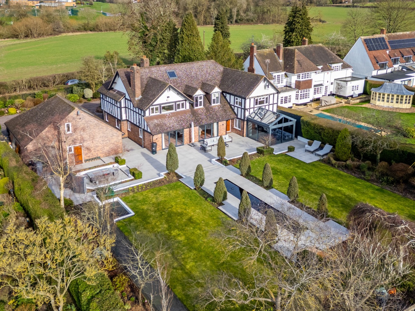 Gated five bedroom detached home on prime Stoughton Lane with south facing landscaped garden. Multiple reception rooms, stunn
